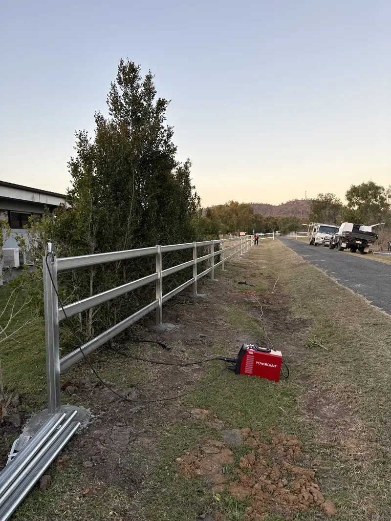 Welded steel rail fence along a rural road